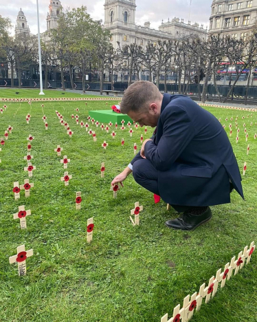 Matt laying a cross in the Westminster remembrance garden